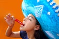 Mexican girl eating red hot chili pepper