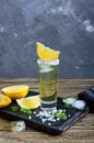 Mexican Gold Tequila in the shot glass with lemon and sea salt on dark table Royalty Free Stock Photo