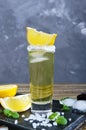 Mexican Gold Tequila in the shot glass with lemon and sea salt on dark table. Royalty Free Stock Photo