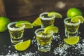 Mexican Gold Tequila shot with lime and salt on black stone table surface Royalty Free Stock Photo