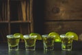 Mexican Gold Tequila shot with lime and salt on black stone table surface Royalty Free Stock Photo