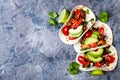 Mexican grilled chicken tacos with avocado, tomato, onion on rustic stone table. Recipe for Cinco de Mayo party.