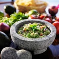 Mexican guacamole in stone molcajete Royalty Free Stock Photo