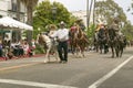 Mexican horseback riders trot along during the opening day parade down State Street of Old Spanish Days Fiesta held every August Royalty Free Stock Photo