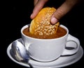 Soaking sweet bread in a cup of mexican hot chocolate Royalty Free Stock Photo