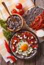 Mexican huevos rancheros on the plate closeup. Vertical top view Royalty Free Stock Photo