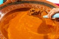 Mexican indigenous woman preparing Mole on a clay pot