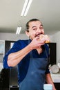 Mexican man eating Pan de Muerto traditional bread for day of the dead in Mexico