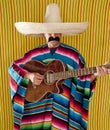 Mexican man serape poncho sombrero playing guitar Royalty Free Stock Photo