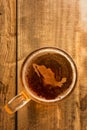 Mexican beer concept, Mexico silhouette on foam in beer glass on wooden table.