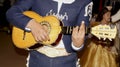 Mexican mariachi plays little guitar