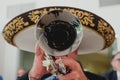 Mexican musician with his trumpet in the foreground, mariachis