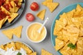 Mexican nacho chips with  sauces on grey table, flat lay Royalty Free Stock Photo