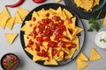 Mexican nacho chips with different sauces on grey table Royalty Free Stock Photo