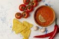 Mexican nacho chips and salsa dip in bowl on wooden background Royalty Free Stock Photo