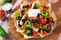 Mexican nacho chips on a wooden paddle board Royalty Free Stock Photo