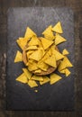 Mexican nacho in wooden bowl on dark rustic background top view