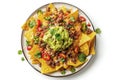 Mexican nachos with beef, guacamole, cheese sauce, peppers, tomato and onion in plate isolated on white background. Top view Royalty Free Stock Photo