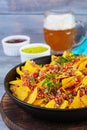 Mexican nachos with cheese. Corn chips with guacamole, salsa and tomato ketchup Royalty Free Stock Photo