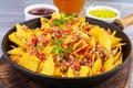 Mexican nachos with cheese. Corn chips with guacamole, salsa and tomato ketchup Royalty Free Stock Photo