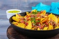 Mexican nachos with cheese. Corn chips with guacamole, salsa and tomato ketchup Royalty Free Stock Photo