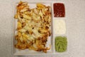 Mexican nachos with chicken. Nachos with corn chips, cheese, salsa, guacamole, sour cream, and chicken. A plate of tortilla nachos Royalty Free Stock Photo