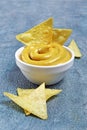 Mexican nachos chips with cheese sauce or dip in white bowl Royalty Free Stock Photo