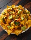 Mexican nachos tortilla chips with olives, jalapeno, guacamole, tomatoes salsa and cheese dip. Royalty Free Stock Photo