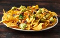 Mexican nachos tortilla chips with olives, jalapeno, guacamole, tomatoes salsa and cheese dip. close up Royalty Free Stock Photo