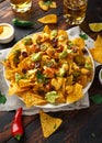 Mexican nachos tortilla chips with olives, jalapeno, guacamole, tomatoes salsa, cheese dipand beer. Royalty Free Stock Photo