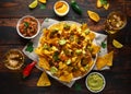 Mexican nachos tortilla chips with olives, jalapeno, guacamole, tomatoes salsa, cheese dipand beer. Royalty Free Stock Photo