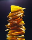 Mexican nachos tortilla chips stack, black background