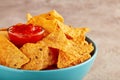 Mexican nachos or tortilla chips in a turquoise bowl with chili salsa dip sauce Royalty Free Stock Photo