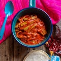 Mexican nopal cactus with guajillo red sauce on wooden background Royalty Free Stock Photo