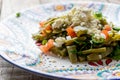 Mexican nopal cactus salad with cheese on wooden background