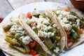 Mexican nopal cactus tacos with cheese on wooden background