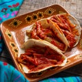 Mexican nopal cactus tacos with guajillo red sauce on wooden background Royalty Free Stock Photo