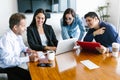 Mexican people in business meeting using computer in office in Latin America