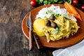 MEXICAN AND PERUVIAN CUISINE. Aji de gallina. Chicken aji de gallina with olives egg and rice on clay plate. Tipical Royalty Free Stock Photo