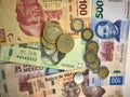 Mexican peso bills spread randomly over a flat surface Royalty Free Stock Photo