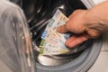 Mexican pesos being thrown into the washing machine, Concept, Money laundering, illegal activity, black market, Criminal activity