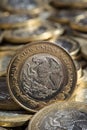 Mexican pesos currency on more coins in disorder, vertical