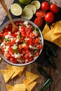 Mexican pico de gallo from tomatoes, onions, cilantro and jalapeno pepper close-up. Vertical top view