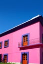 Mexican pink house facade wooden doors Royalty Free Stock Photo