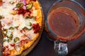 Mexican pizza with a michelada drink with beer and clamato on the side Royalty Free Stock Photo