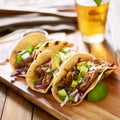 Mexican pork carnitas tacos on yellow corn tortilla