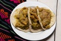 Mexican pork chicharron with green sauce tacos on white background