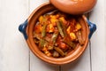 Mexican potato and nopal cactus stew with red sauce on white background