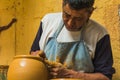 Mexican potter craftsman, working the clay with his hands