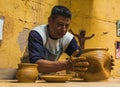 Mexican potter craftsman, working the clay with his hands